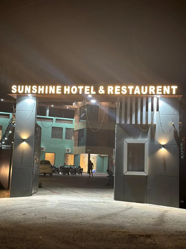 Hotel Sunshine illuminated entrance at night
